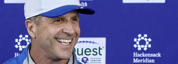 New York Giants coach John Harbaugh laughs during a press-conference