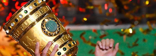 The German DFB Pokal trophy is held aloft after the soccer final